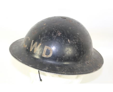 A WWII era Home Front steel helmet marked to front C.W.D. 