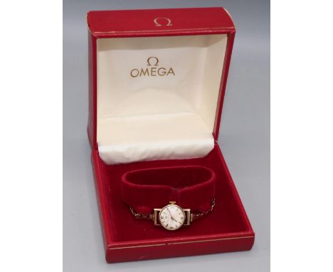 Ladies Omega gold wristwatch on matched gold hallmarked bracelet, signed silvered dial with applied Arabic and baton hours, s