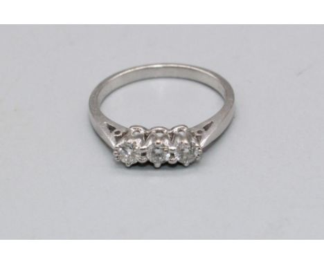 18ct white gold three stone diamond ring, set with three brilliant cut diamonds, stamped 750, size L, 2.9g 