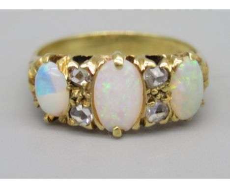 18ct yellow gold opal and diamond ring, the three cabochon opals separated by brilliant cut diamonds, stamped 18, size J, 3.6