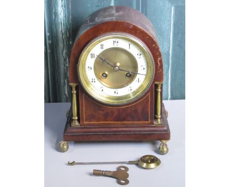 Edwardian inlaid mahogany arched top mantle clock with circular Arabic chapter, brass columns and claw and ball feet, twin tr