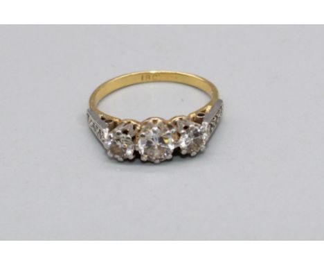 18ct yellow gold three stone diamond ring, on diamond set shoulders, stamped 18, size J, 3.0g 