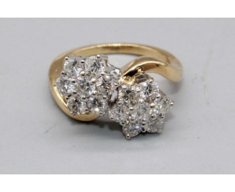 18ct yellow gold double floral cluster ring, each cluster set with seven brilliant cut diamonds in claw mounts, on plain shan