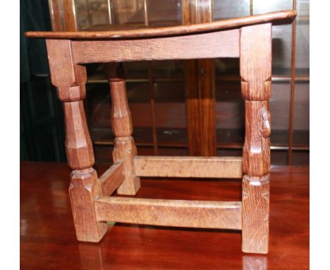 Robert Mouseman Thompson of Kilburn - an oak joint type stool, nailed rectangular adzed dished top on faceted supports, carve