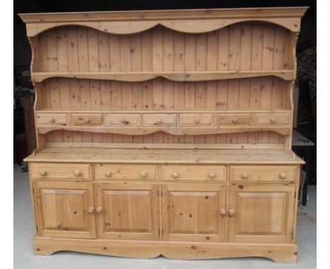 Large Country House style waxed pine dresser, twin shelf back with seven spice drawers, base with four drawers and four panel