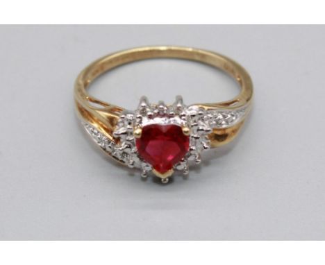 10ct yellow gold ring set with ruby heart cut stone surrounded by a halo of diamonds, on diamond twist shoulders, stamped 10k