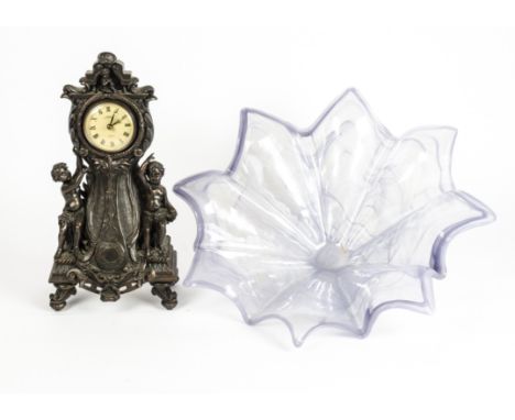 A large piece of decorative glass,  diameter 55.5cm, together with a clock standing on four feet with cherubic surround, heig