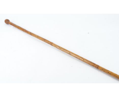 A tribal bamboo stick possibly Indian,  with metal tip, carved with extensive decoration, length 171 cm  