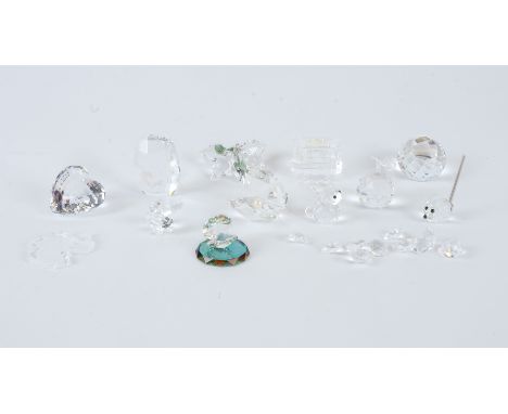 Twelve small Swarovski crystal pieces,  to include clam shells opening to reveal pearls, a train carriage and apple and many 