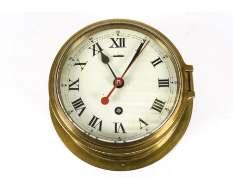 A brass cased ship clock, the circular dial set with Roman numerals, clockwork mechanism, unmarked, dial diameter 14.5cm 