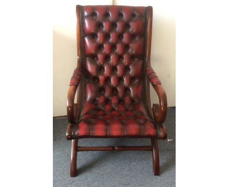 A 20th Century mahogany and chestnut leather armchair, button back design, 59cm wide x 97cm high  