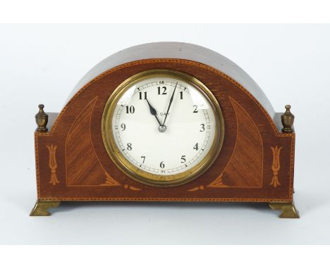 An early 20th Century eight day mantel clock,  the surround with inlaid crossbanded decoration, on four splayed feet, height 