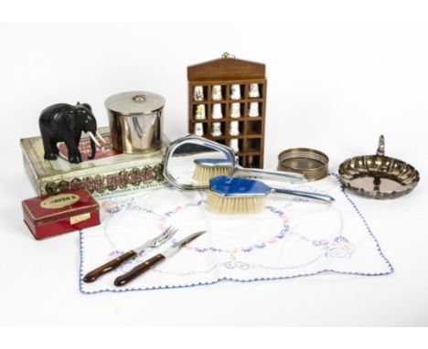 A plated metal blue enamel dressing table set,  consisting of mirror, brushes and pots, together with two carved wooden eleph