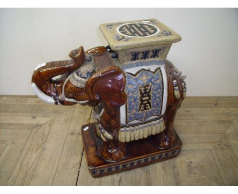 A mottled glazed ceramic elephant stool (56 cm high) 