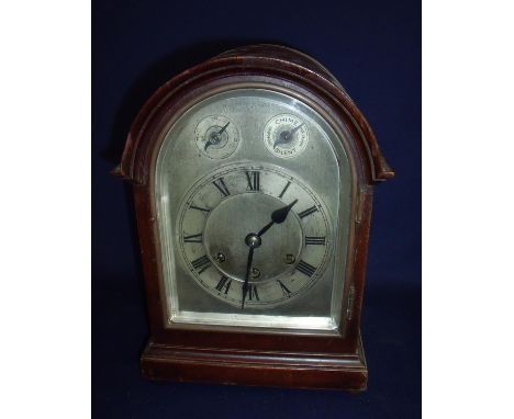 Cased Gustav Becker chiming mantel clock with steel face enclosed by bevel edged panelled door, with arched top on stepped re