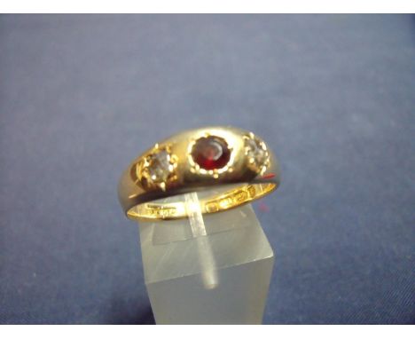 18ct gold gypsy style rub over ring set with central ruby flanked by two diamonds 