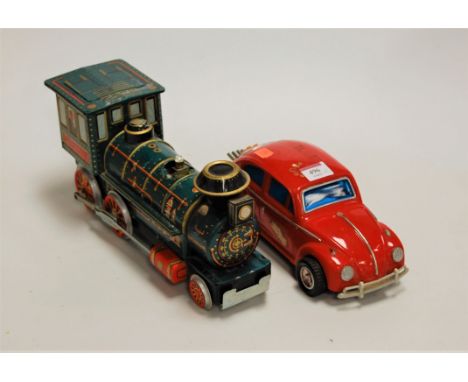 A Chinese battery operated model of a Volkswagen Beetle together with a tinplate Western locomotive