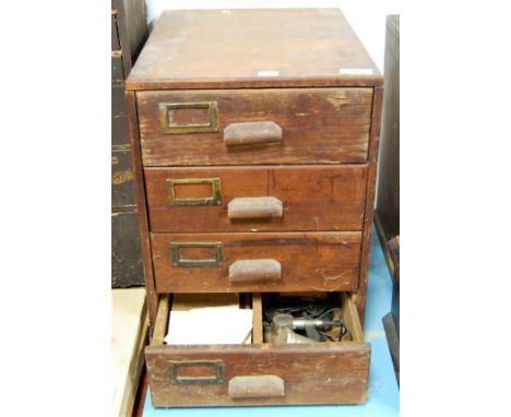 A pine four drawer chest containing a large quantity of pocket watch parts, dials, assorted watchmaker's tools, etc, chest he