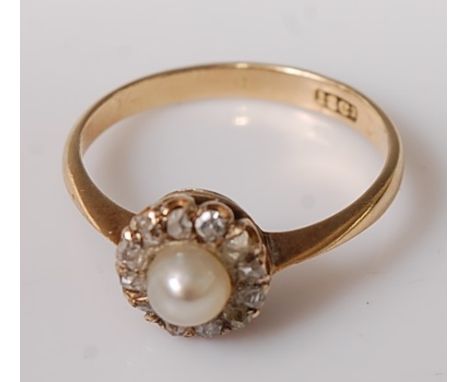 An 18ct gold, cultured pearl and diamond dress ring, the single pearl in a surround of twelve small rose cut diamonds, 2.1g, 