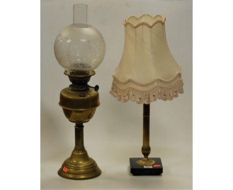 An early 20th century brass pedestal oil lamp having etched globular shade, together with a brass table lamp and shade (2)