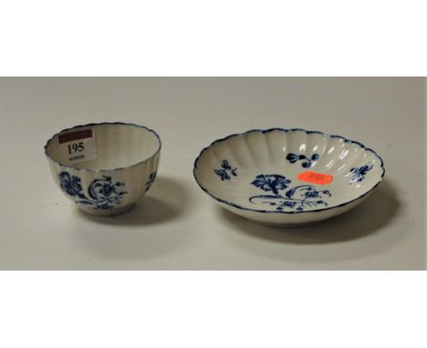 An 18th century Worcester porcelain tea bowl and saucer, the bowl decorated with flowers, with matching saucer, having cresce