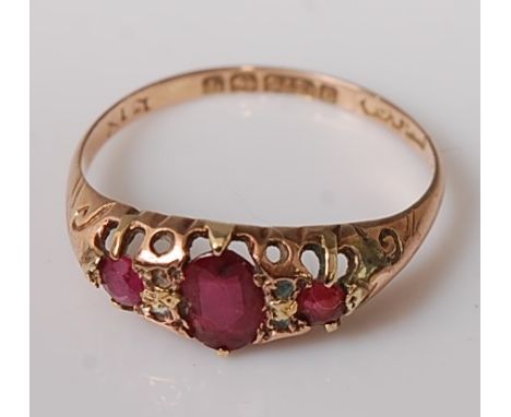 A vintage 9ct gold, ruby and diamond point set dress ring, the oval rubies in a carved setting, 1.6g, size Q