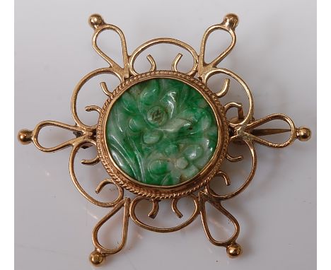 A carved green and celadon jade flower head disc, in 9ct gold mount as a brooch, 7.4g, dia.4cm