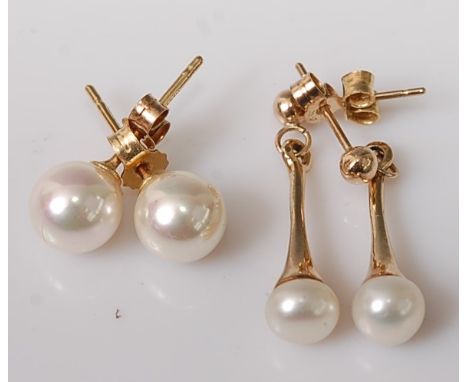A pair of 18ct gold cultured pearl set ear studs; together with a pair of yellow metal and cultured pearl set drop ear studs 