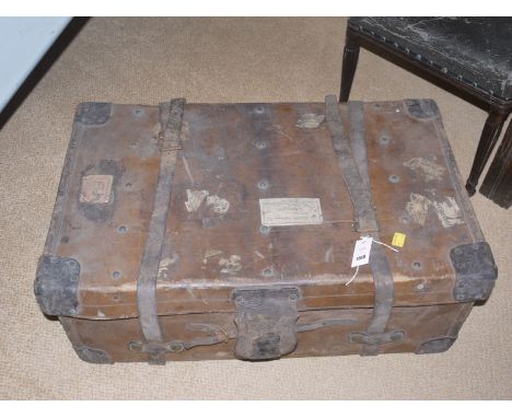 A large leather trunk with reinforced corners and leather straps.