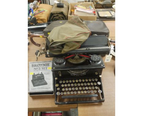 A Brownie No. 3 set for all wavelengths; a Vintage typewriter; two telephones; and two walking sticks.