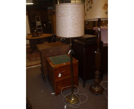 An early brass standard lamp (converted to electricity), complete with a modern shade.