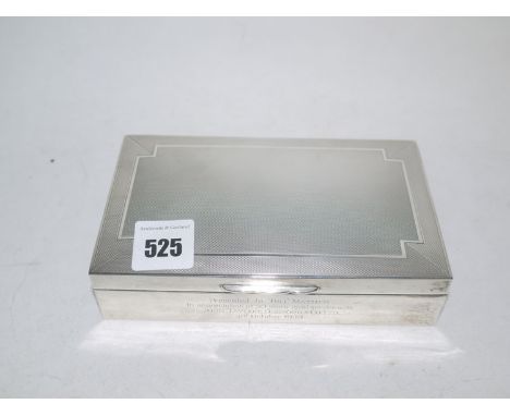 A silver mounted cigarette case with presentation inscription to front, engine turning to lid.