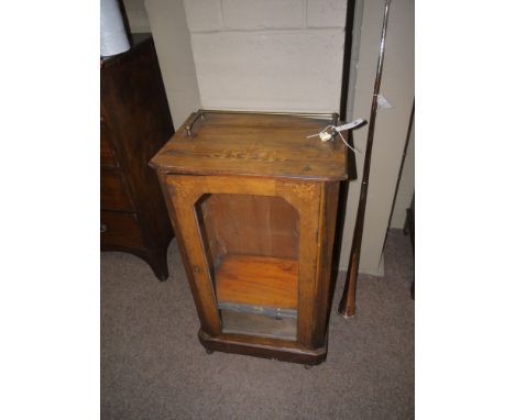 A late 19th Century inlaid walnut music cabinet with brass gallery, canted corners and a single glazed panel door enclosing s