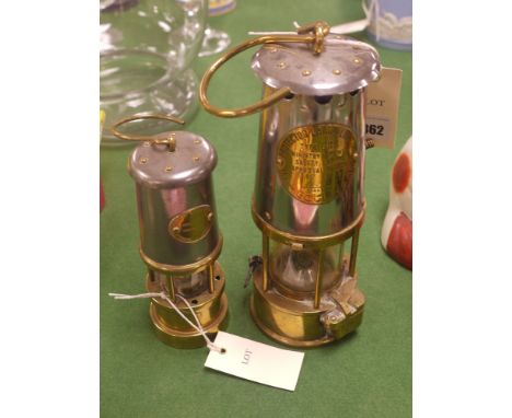 A miner's lamp by the Protector Lamp & Lighting Co., Type GRS; together with a small reproduction miner's lamp by the Lamp & 