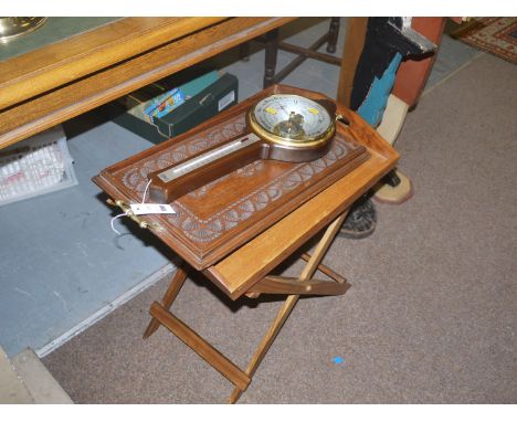 A stained wood tray and folding stand; a carved and stained hardwood tray with brass handles; and a modern barometer and ther