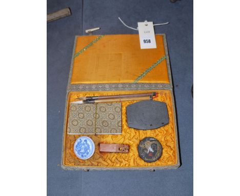A Chinese writing set in fitted case, with two bamboo tip pens, a notebook, two moulded ink block, a carved stone block, and 