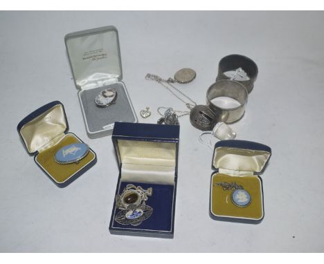 A filigree brooch; and a filigree pendant; a carved shell cameo brooch; a white metal locket pendant; a decanter stopper with