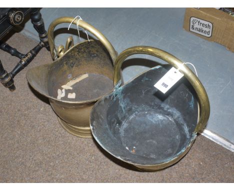 Two brass helmet-shaped coal scuttles with swing handles.