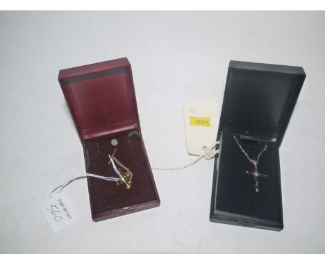 An amethyst and diamond crucifix pendant on 9ct. gold shank, fine link chain; together with another plain pattern lapel.