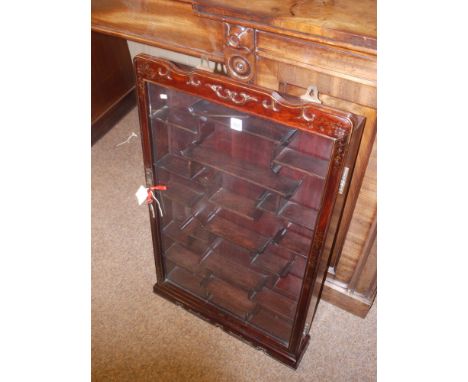 A modern Oriental style hardwood wall mounted display cabinet, fitted a single glazed panel door enclosing a variety of shelv