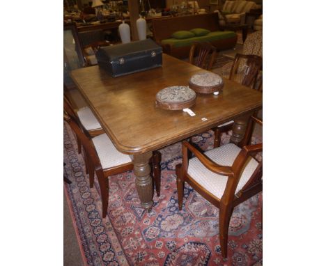 A Victorian oak telescopic extending dining table, with moulded edge and rounded corners, raised on turned and reeded stout l