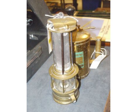 A "Clanny" miner's lamp with arched hinged top, stamped 'Henry Watson, Newcastle on Tyne', supported by three steel bars over