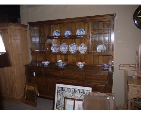 A late 20th Century dresser, with panelled two-tier delft rack containing two cupboards with leaded glass panel doors, fitted