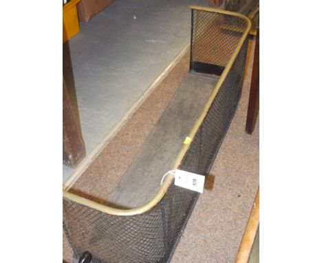 A 19th Century wire mesh fireguard with brass rail and black painted metal base, 36in. wide.