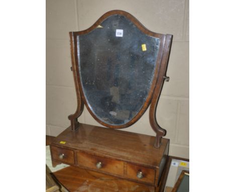 A Georgian swing toilet mirror, with shield-shaped mirror on slender supports, the rectangular base containing three drawers 