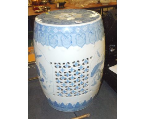 A reproduction Chinese ceramic barrel form garden stool, with blue underglaze decoration on white ground and pierced decorati
