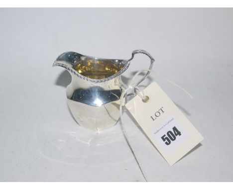 A silver helmet form cream jug, by S.B. & S. Ltd., Birmingham 1907, with gadrooned rim, acanthus capped scrolling handle and 
