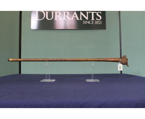 A very unusual sword stick with brass dragons head top and ornate metal bound scabbard