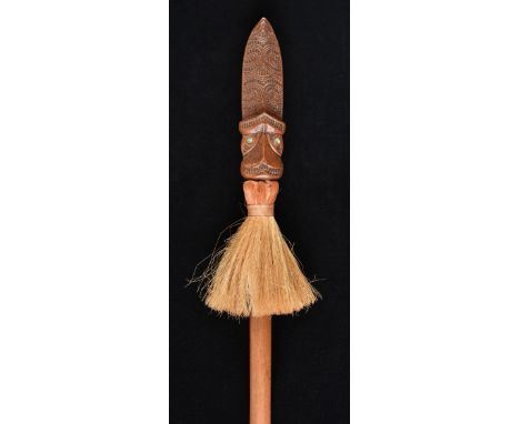 * Maori Staff. A late 20th century Taiaha, with carved spear head inset with mother of pearl and grass on a flattened shaft, 
