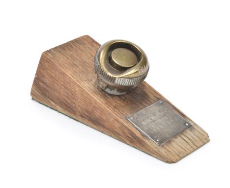 * Spitfire. A WWII Spitfire brass spade grip firing button, mounted on an oak block with white metal plaque engraved 'Gun But